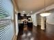 Open-concept living area with hardwood floors and view into modern kitchen at 2249 Knoxhill Se Vw, Smyrna, GA 30082