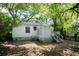 View of the home's backyard featuring a screened-in porch and mature shade trees at 311 Henry Aaron Ave, Atlanta, GA 30310