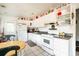 Functional kitchen with white cabinets, classic appliances, and adjacent dining area with tile floor at 311 Henry Aaron Ave, Atlanta, GA 30310