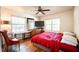 Cozy bedroom with hardwood floors, ceiling fan, and large windows offering natural light and spacious closet at 311 Henry Aaron Ave, Atlanta, GA 30310