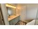 Bathroom featuring double sinks, tiled floors and a large mirror with Hollywood lighting at 3858 Glenlake Dr, Douglasville, GA 30134