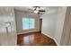 Bright bedroom features gleaming hardwood floors, large windows and a modern ceiling fan at 3858 Glenlake Dr, Douglasville, GA 30134