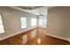 Bedroom with hardwood floors, tray ceiling, and plenty of natural light from windows at 3858 Glenlake Dr, Douglasville, GA 30134