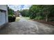 Long driveway leading to a two-story house with a well-maintained lawn and mature trees at 3858 Glenlake Dr, Douglasville, GA 30134