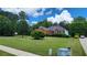 Beautiful red brick home with lush front lawn, mature trees, and manicured landscaping at 3858 Glenlake Dr, Douglasville, GA 30134