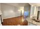 Open living room with hardwood floors, fireplace, and kitchen with granite countertops at 3858 Glenlake Dr, Douglasville, GA 30134