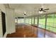 Well-lit sunroom with hardwood floors, paneled ceiling and many windows overlooking backyard at 3858 Glenlake Dr, Douglasville, GA 30134