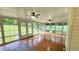Bright sunroom with hardwood floors, paneled ceiling and large windows overlooking backyard at 3858 Glenlake Dr, Douglasville, GA 30134