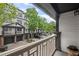 A balcony with a view of townhome exteriors, landscaping, and parking at 221 Semel Nw Dr # 273, Atlanta, GA 30309