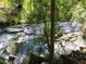 Babbling brook with natural stone and foliage enhances the outdoor retreat at 221 Semel Nw Dr # 273, Atlanta, GA 30309