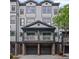 Exterior of new townhomes with gray siding, stone accents, and garage parking at 221 Semel Nw Dr # 273, Atlanta, GA 30309