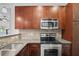 Well-equipped kitchen features sleek, stainless steel appliances, granite countertops, and stylish tile backsplash at 221 Semel Nw Dr # 273, Atlanta, GA 30309