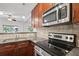 Modern kitchen featuring stainless steel appliances, granite countertops, and hardwood cabinets at 221 Semel Nw Dr # 273, Atlanta, GA 30309