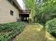 View of the backyard of a home with a brick exterior, wooden deck, and lawn at 2636 Whiteleigh Ne Ct, Atlanta, GA 30345
