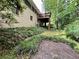 View of the backyard of a home with a brick exterior, wooden deck, and lush landscaping at 2636 Whiteleigh Ne Ct, Atlanta, GA 30345