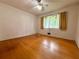 Sunlit bedroom features a ceiling fan, window, and hardwood floors at 2636 Whiteleigh Ne Ct, Atlanta, GA 30345