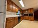Kitchen featuring wood cabinetry, vinyl flooring and white appliances at 2636 Whiteleigh Ne Ct, Atlanta, GA 30345