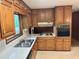 This kitchen features wood cabinets, white countertops and black appliances at 2636 Whiteleigh Ne Ct, Atlanta, GA 30345