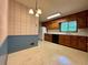 Kitchen featuring wood cabinets, white appliances, and vinyl flooring at 2636 Whiteleigh Ne Ct, Atlanta, GA 30345