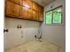Laundry room with cabinets and a window for natural light at 2636 Whiteleigh Ne Ct, Atlanta, GA 30345