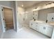 Contemporary bathroom features a glass-enclosed shower, double vanity with sleek fixtures and convenient closet access at 5710 Urban Village Way # 6, Tucker, GA 30084