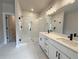 Elegant bathroom featuring double vanity with sleek fixtures, a glass-enclosed shower, and modern lighting at 5710 Urban Village Way # 6, Tucker, GA 30084