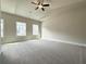 Spacious bedroom featuring vaulted ceiling with fan, neutral carpeting, and abundant natural light from multiple windows at 5710 Urban Village Way # 6, Tucker, GA 30084