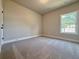Comfortable bedroom with soft carpeting, natural light, and a soothing neutral color palette at 5710 Urban Village Way # 6, Tucker, GA 30084
