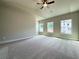 Large bedroom with vaulted ceilings, ceiling fan, and generous windows offering ample natural light and comfortable carpet at 5710 Urban Village Way # 6, Tucker, GA 30084