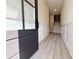 Bright foyer with modern wood flooring, decorative wainscotting, and a staircase to the upper level at 5710 Urban Village Way # 6, Tucker, GA 30084