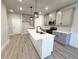 Modern kitchen with a large center island, sleek gray cabinetry, stainless appliances, and stylish pendant lighting at 5710 Urban Village Way # 6, Tucker, GA 30084