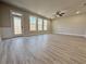 Open living room featuring hardwood floors, large windows, and ample natural light, perfect for entertaining at 5710 Urban Village Way # 6, Tucker, GA 30084