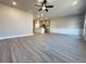 Spacious living room featuring modern ceiling fan, beautiful flooring, and an open floor plan at 5710 Urban Village Way # 6, Tucker, GA 30084