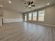 Open living room bathed in natural light from three large windows with views of the outdoors at 5710 Urban Village Way # 6, Tucker, GA 30084