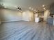 Spacious living room with hardwood floors, a ceiling fan, and an open-concept design leading to the kitchen at 5710 Urban Village Way # 6, Tucker, GA 30084