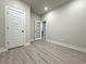 Room featuring a doorway, neutral paint, modern flooring, ample natural light, and modern doors at 5710 Urban Village Way # 6, Tucker, GA 30084