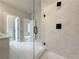Modern shower featuring a frameless glass enclosure, large tile surround, and black fixtures, offering a spa-like experience at 5710 Urban Village Way # 6, Tucker, GA 30084