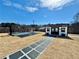 Expansive backyard with a modern shed, basketball court, and stylish hardscape at 590 Hood Ave, Fayetteville, GA 30214