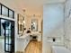 Elegant bathroom with double vanity, marble countertops, herringbone tile accent wall, and modern lighting at 590 Hood Ave, Fayetteville, GA 30214