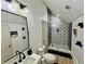 Bathroom with a sink, toilet, and stylish black and white tiled shower at 590 Hood Ave, Fayetteville, GA 30214