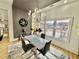 Dining room with seating for four, a chandelier, wood accent wall, and large windows at 590 Hood Ave, Fayetteville, GA 30214