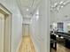 Hallway with modern decor, chandelier lighting and decorative wall accents, leading to living spaces at 590 Hood Ave, Fayetteville, GA 30214