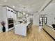 Open kitchen with white cabinets, stainless steel appliances, and a large center island at 590 Hood Ave, Fayetteville, GA 30214