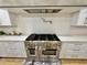 Gourmet kitchen features a large gas range, custom cabinetry, and stone countertops at 590 Hood Ave, Fayetteville, GA 30214