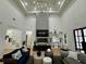 Bright living room boasting a fireplace, large windows, high ceilings, and modern decor at 590 Hood Ave, Fayetteville, GA 30214