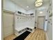 Mudroom with white bench, coat hooks, storage, and light wood flooring at 590 Hood Ave, Fayetteville, GA 30214