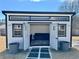 A modern shed with an open doorway, windows, and stylish exterior, enhancing backyard aesthetics at 590 Hood Ave, Fayetteville, GA 30214