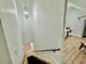Bright staircase with wooden steps, black runner, and modern light fixture at 590 Hood Ave, Fayetteville, GA 30214
