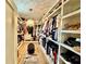 Spacious walk-in closet with custom shelving, ample storage space, and stylish lighting fixture at 590 Hood Ave, Fayetteville, GA 30214
