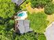 Aerial view of a home with a backyard pool and a deck surrounded by lush greenery at 214 Kingsley Way, Woodstock, GA 30188